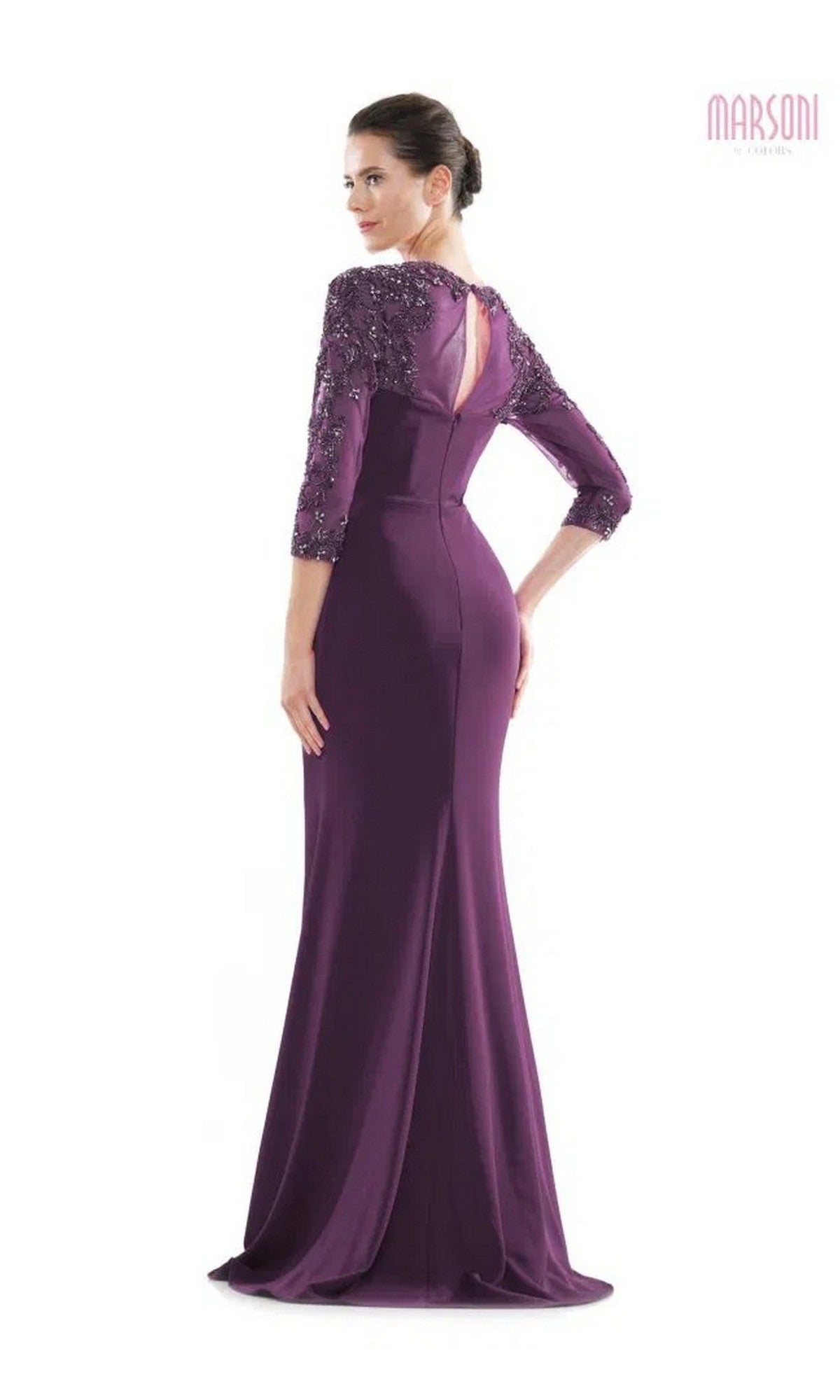 A woman stands with her back to the camera in a floor-length purple Long Formal Dress: Marsoni MV1070, featuring three-quarter sleeves and beaded embellishments.
